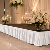 Elegant wedding stage with white floral arrangements and candles