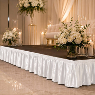 Elegant wedding stage with white floral arrangements and candles