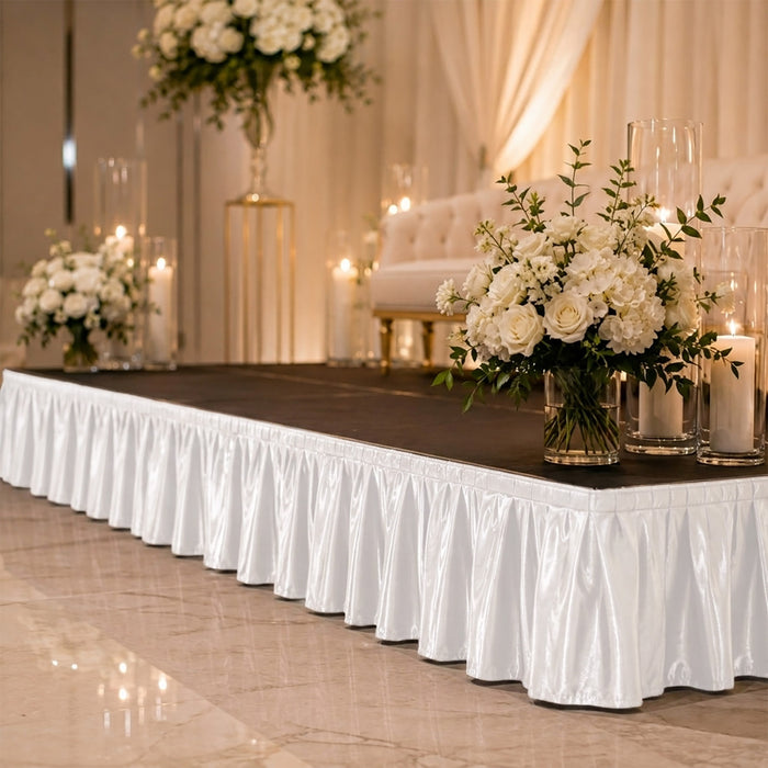 Elegant wedding stage with white floral arrangements and candles