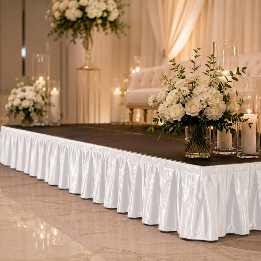 Elegant wedding stage with white floral arrangements and candles