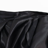Black satin fabric texture with soft folds and glossy sheen
