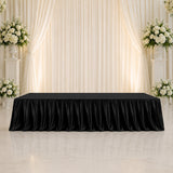 Elegant black tablecloth on wedding stage with white floral backdrop