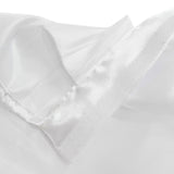 Close-up of white satin fabric with soft folds and stitching