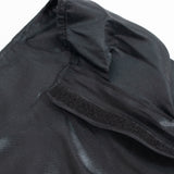 Black fabric hat with Velcro strap close-up