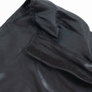 Black fabric hat with Velcro strap close-up