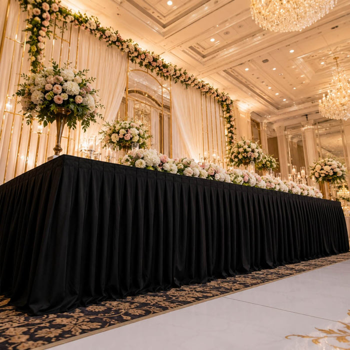 Elegant wedding reception stage with floral arch and chandelier lighting