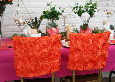 Orange rosette chair covers at decorated table