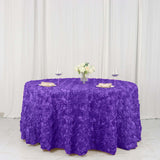 Purple rose-patterned tablecloth with floral centerpiece and glasses.