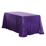 Purple sequin tablecloth draping over a rectangular table.