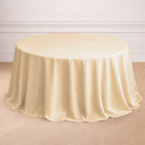 Ivory round tablecloth draping elegantly over a table in a staged setting.