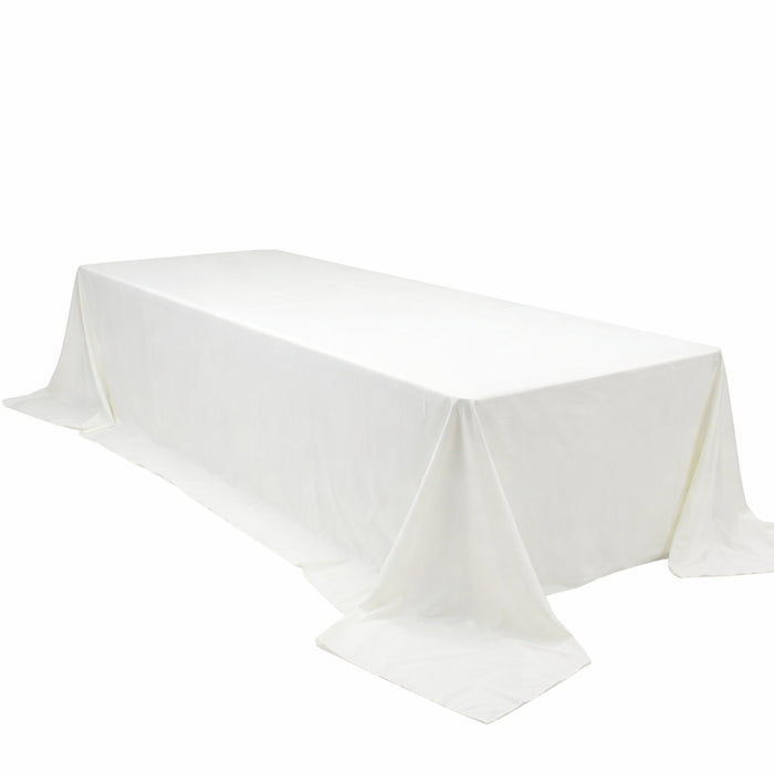 White rectangular table with draped tablecloth