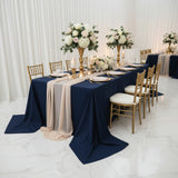 Elegant banquet setup with navy tablecloths, floral centerpieces, and gold accents.