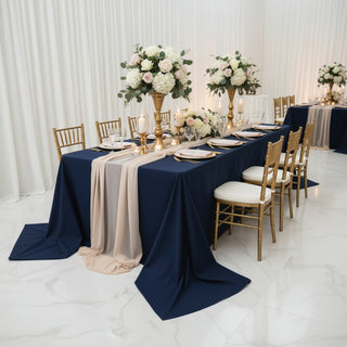 Elegant banquet setup with navy tablecloths, floral centerpieces, and gold accents.