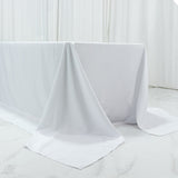White tablecloth draped over a table in a bright, minimalistic setting.