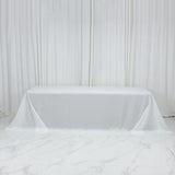 White tablecloth draped over a table in a studio setting.