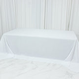 White tablecloth draped over a table in a studio setting.
