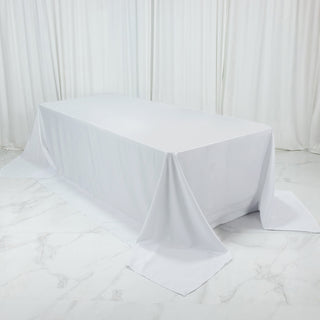 White tablecloth draped over a table in a studio setting.