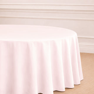 Round pink tablecloth draping elegantly over a table.