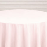 Round pink tablecloth on a smooth surface