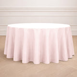 Pink round tablecloth on a wooden floor with elegant draping.
