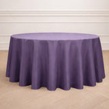 Round purple tablecloth on a light wooden floor.