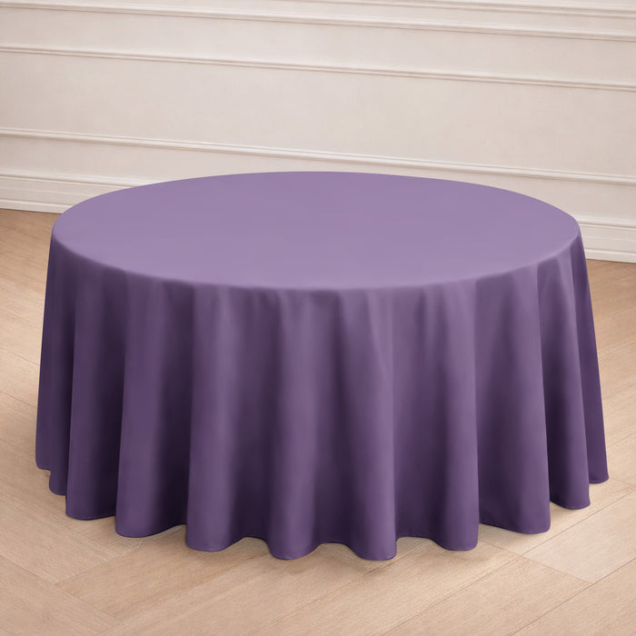 Purple round tablecloth on a wooden floor backdrop.
