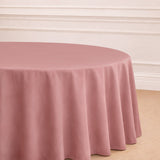 Round pink tablecloth draping elegantly over a table in a staged setting.