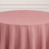 Pink tablecloth draping over a round table in a neutral setting.