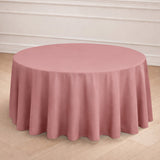 Round pink tablecloth draped elegantly over a table in a styled setting.