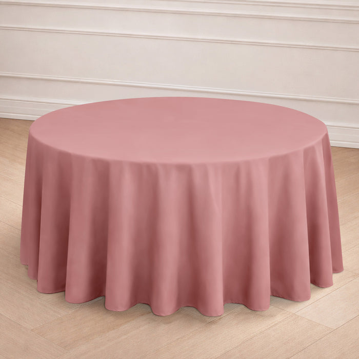 Round pink tablecloth draped elegantly over a table in a styled setting.
