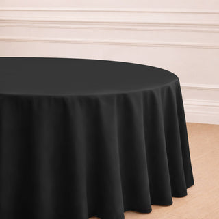 Black round tablecloth draping elegantly over a table in a stylish setting.