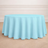 Round light blue tablecloth draped over a circular table.