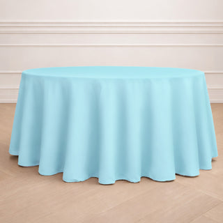Round light blue tablecloth draped over a circular table.