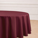 Burgundy round tablecloth draping elegantly over a table.