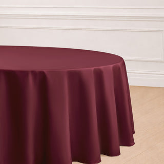 Burgundy round tablecloth draping elegantly over a table.