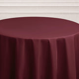 Burgundy tablecloth draped elegantly over a round table.