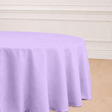 Purple round tablecloth on a wooden floor.