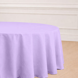 Purple round tablecloth on a wooden floor.