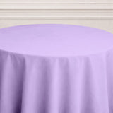 Purple round tablecloth on a table with a neutral background.