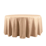 Round beige tablecloth on a plain backdrop