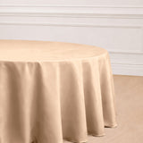 Beige round tablecloth draping elegantly over a table.