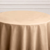 Beige round tablecloth on a table with a soft texture.