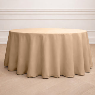 Round beige tablecloth on a round table in a minimalist setting.