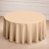 Beige round tablecloth draped elegantly over a circular table.