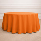 Orange round tablecloth on a wooden floor.