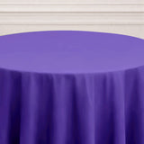 Purple tablecloth on a round table against a light background.