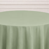 Round green tablecloth on a plain backdrop.