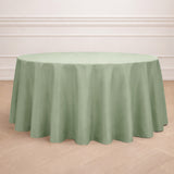 Round green tablecloth on a wooden floor backdrop.