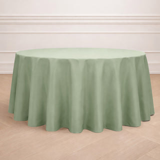 Round green tablecloth on a wooden floor backdrop.