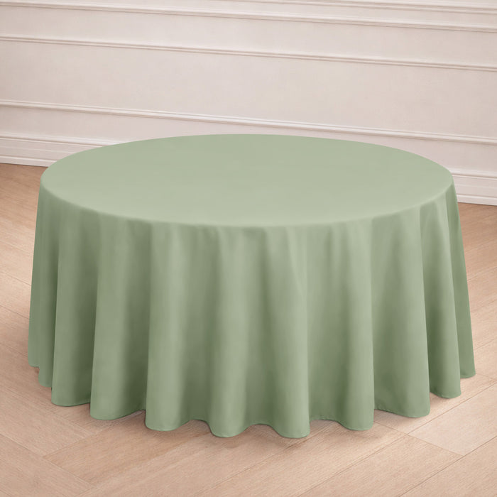 Round green tablecloth draped elegantly on a table in a styled setting.